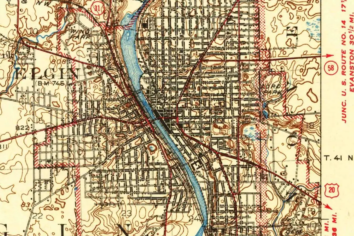 Detail of a U.S. Geological Survey map of Elgin showing the city's street grid on both banks of the Fox River, with the word ELGIN printed on the west side and red highway markings for U.S. Route 20