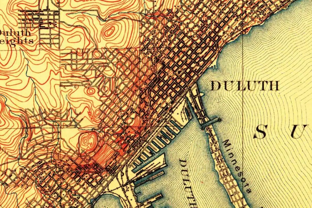 Detail of an 1895 U.S. Geological Survey map showing Duluth's street grid climbing the hillside above the harbor, the word DULUTH over Lake Superior, Minnesota Point and Duluth Heights