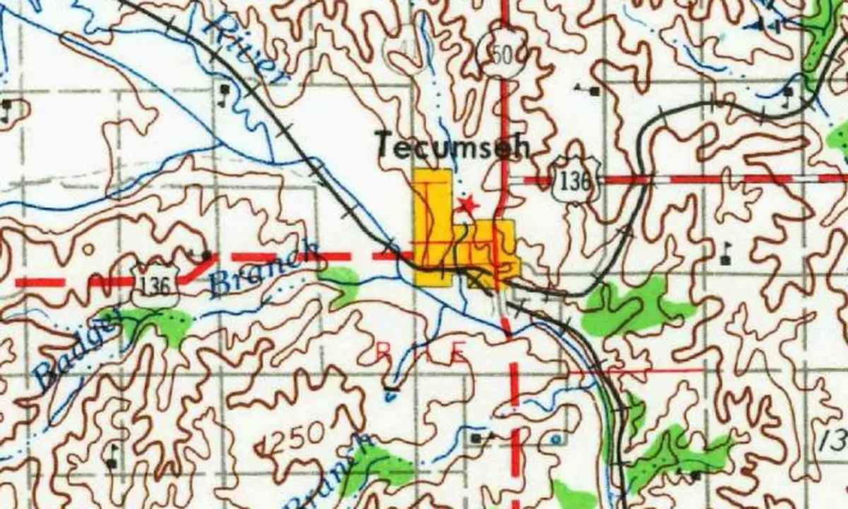 Detail of a 1955 U.S. Geological Survey map showing Tecumseh in yellow beside a river, where U.S. 136 crosses the railroad