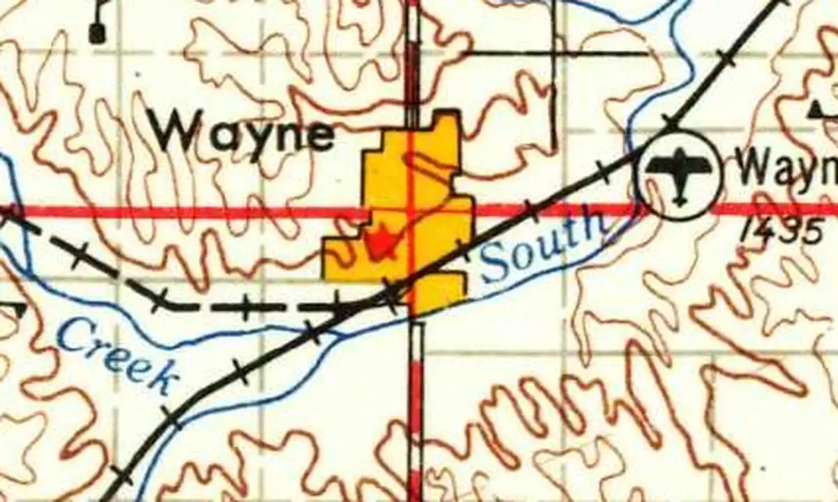 Detail of a 1955 U.S. Geological Survey map showing Wayne in yellow with the railroad and a creek along its south side and the Wayne airport to the east