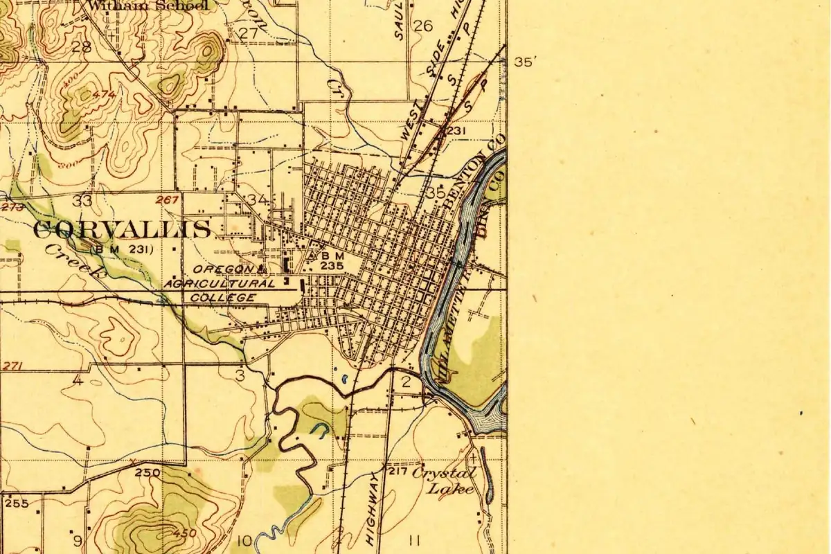Detail of a 1921 U.S. Geological Survey map showing the street grid of Corvallis beside the Willamette River, with the name CORVALLIS and the Oregon Agricultural College marked west of downtown, and the blank margin of the sheet on the right
