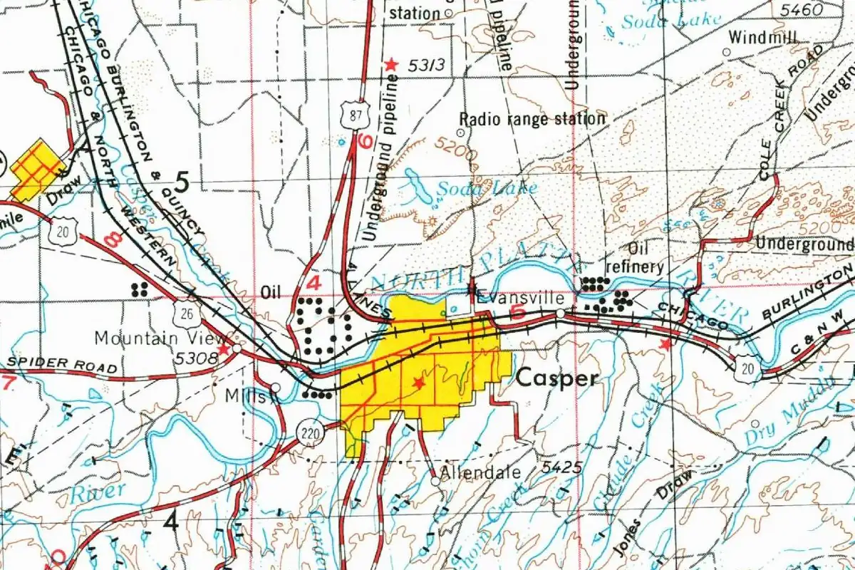 Detail of a mid-century topographic map showing Casper as a yellow built-up area south of the North Platte River, with Mills to the west, Evansville to the northeast and rail lines running through town